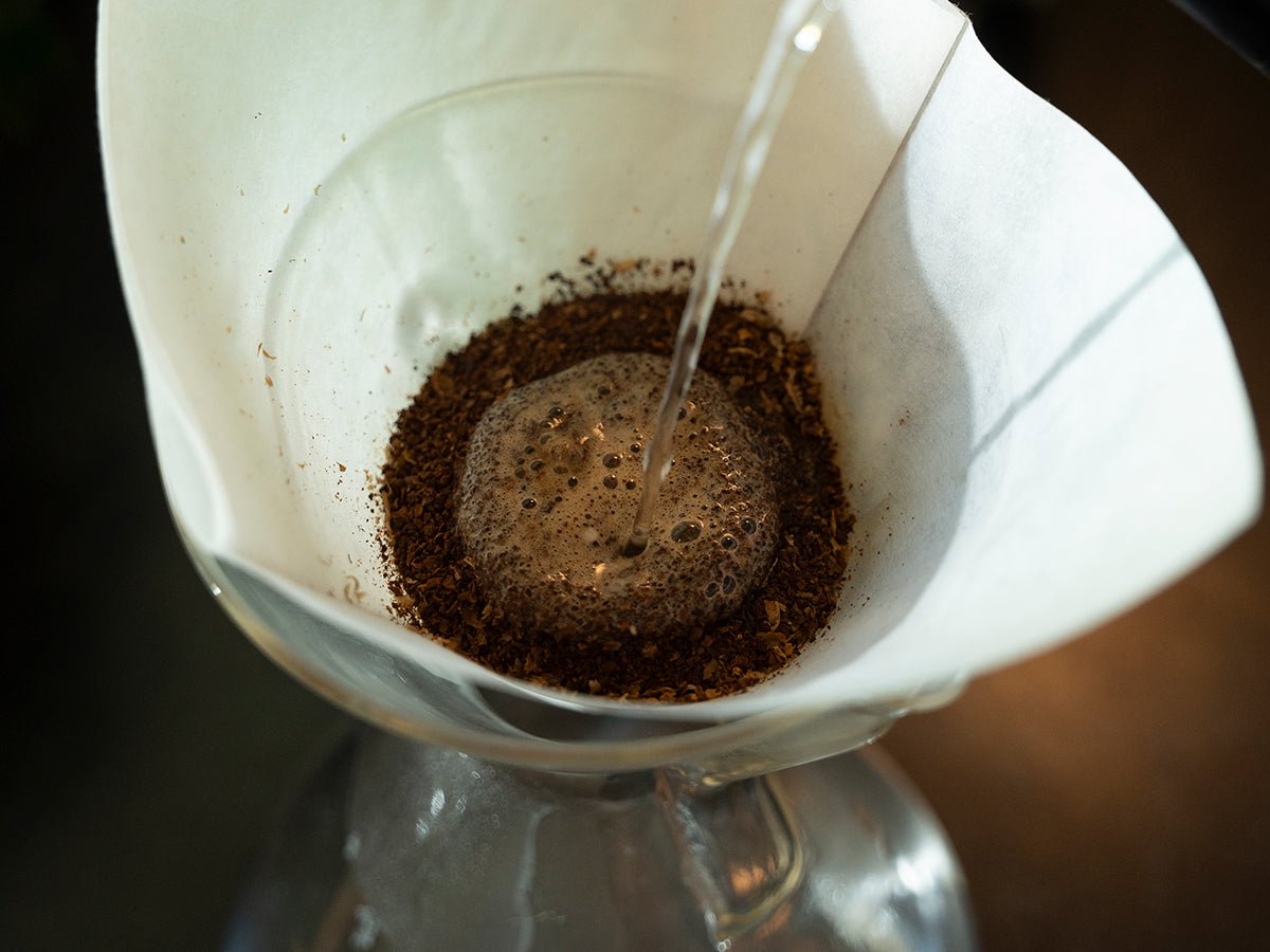 A modern drip coffee maker preparing a fresh pot of coffee in a kitchen.