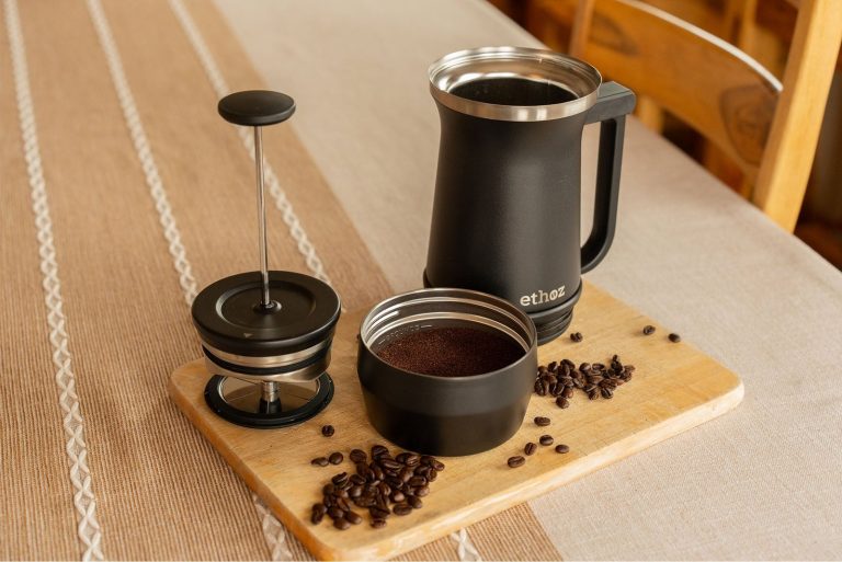 A modern coffee machine brewing a fresh cup of coffee in a kitchen.