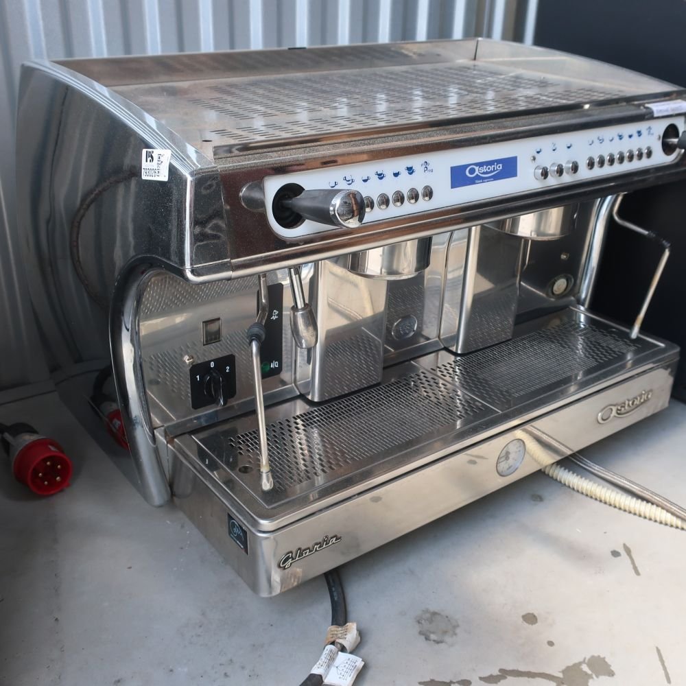 Adjusting the pressurestat inside an Astoria Gloria espresso machine for optimal boiler performance.