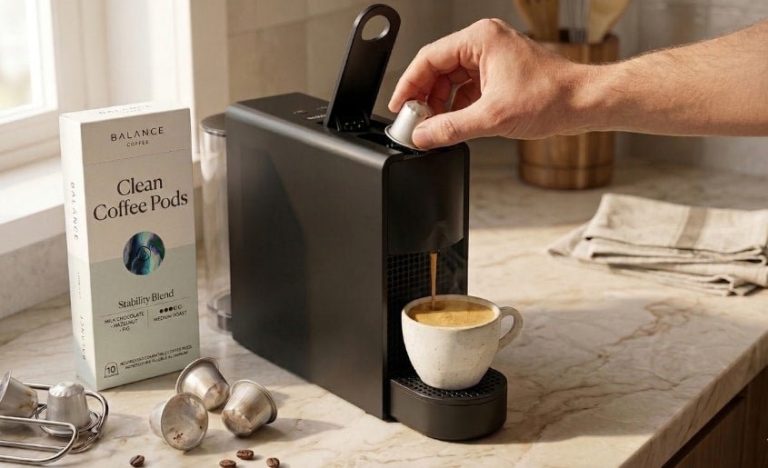 A close-up of an espresso machine extracting coffee from an ESE pod.