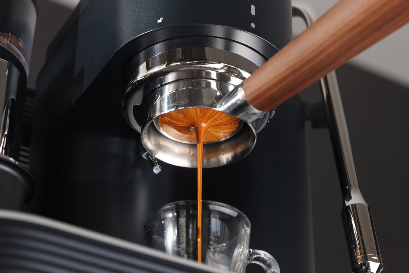 A clean coffee station with espresso tools arranged neatly on a wooden table.